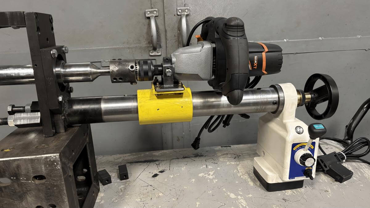 IRM Power Feed Assembly driving a boring bar with a handheld drill