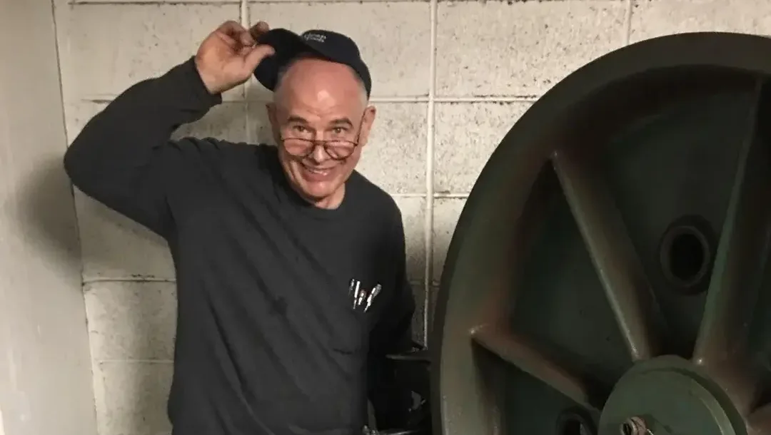 Anguel Bojinov standing next to an elevator sheave